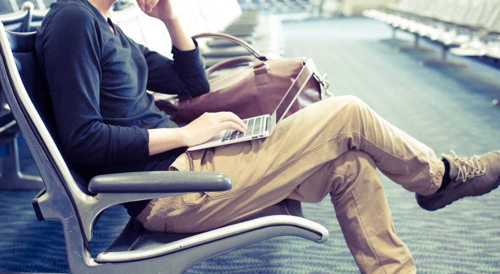 Man at Airport on Laptop