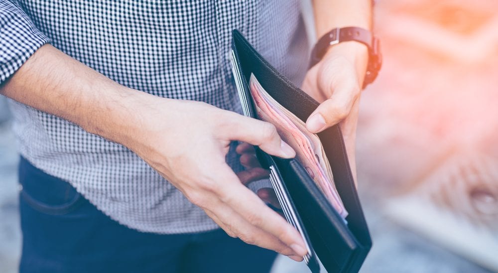 Man with wallet - financial wellbeing